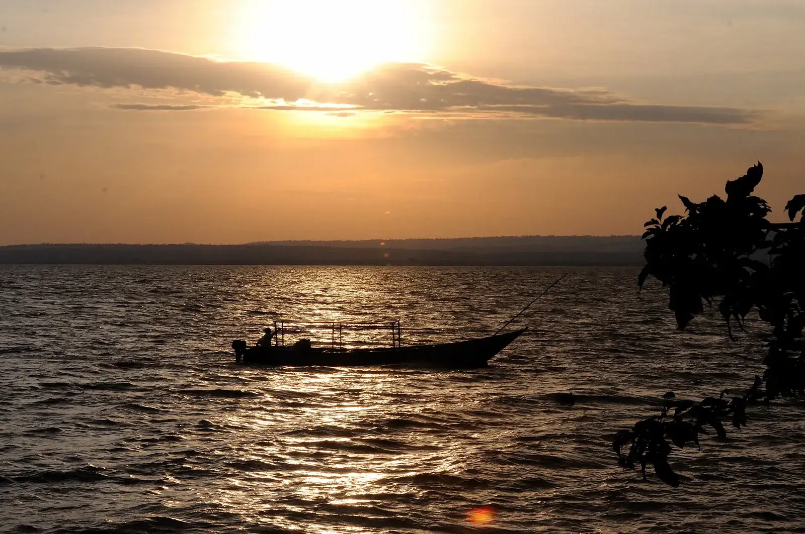 A fishing boat on Lake Victoria at sunset near Kisumu, Kenya.