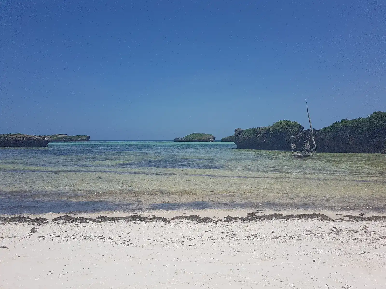 Boats and shallow coastal water at Watamu Beach, Kenya.